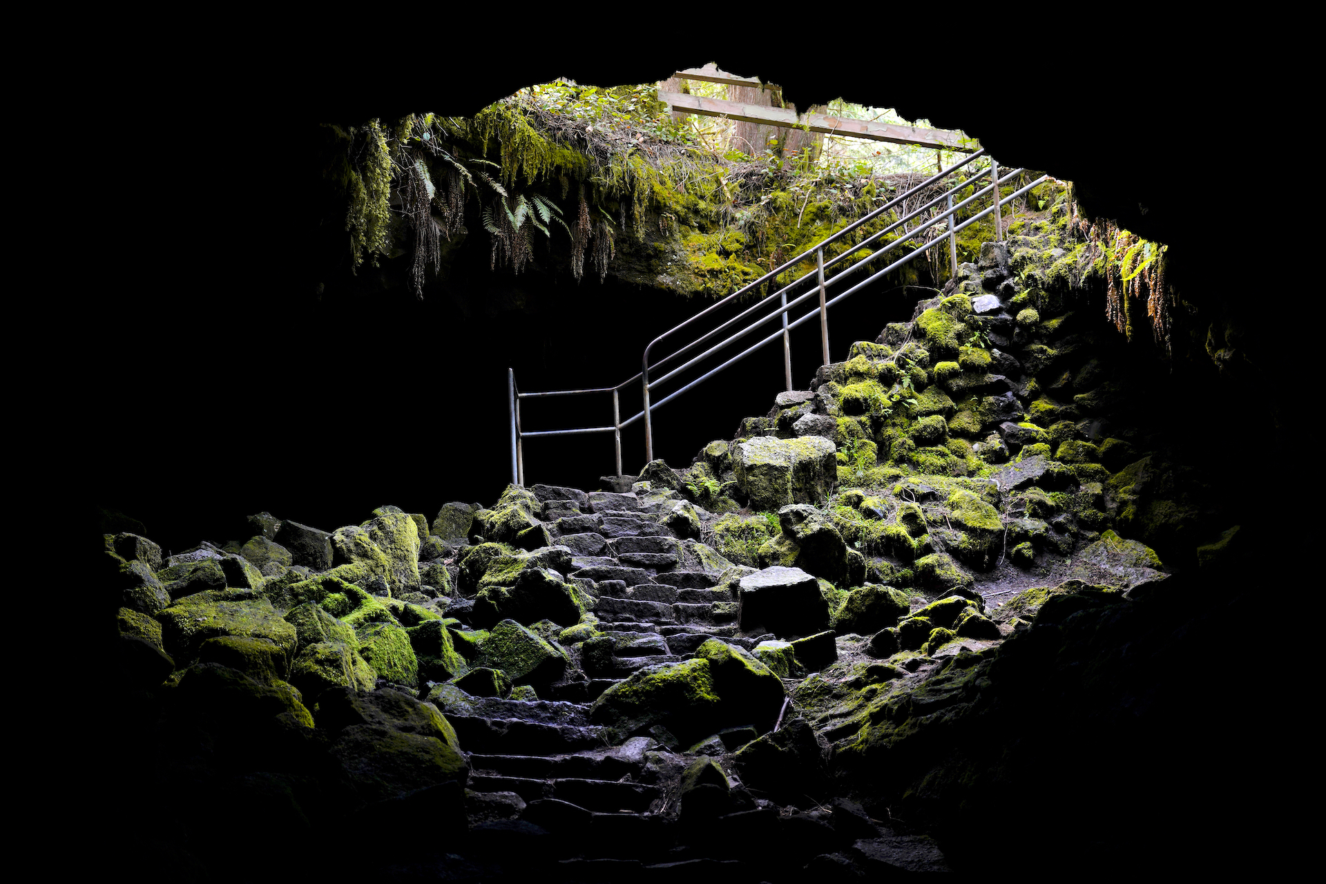 Stairs descend into the darkness at the main entrance to Ape Cave in Mt St Helens National Monument.