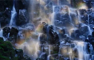 A rainbow crosses the face of Ramona Falls.