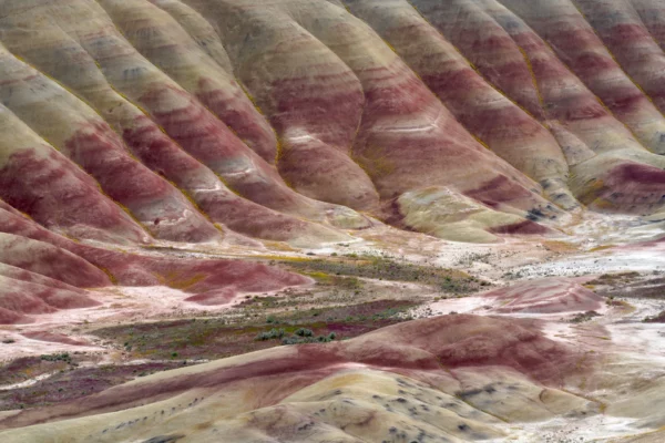 Horizontal stripes of red cross the hillside at Painted Hills.