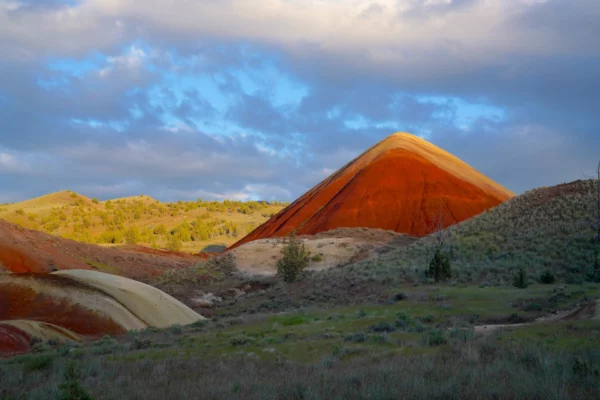 The last rays of sun touch aptly-named Red Hill as the desert around it sinks into shadow.