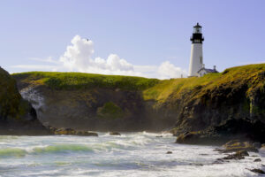 Yaquina Head Lighthouse stands above jade seas on the Oregon Coast.