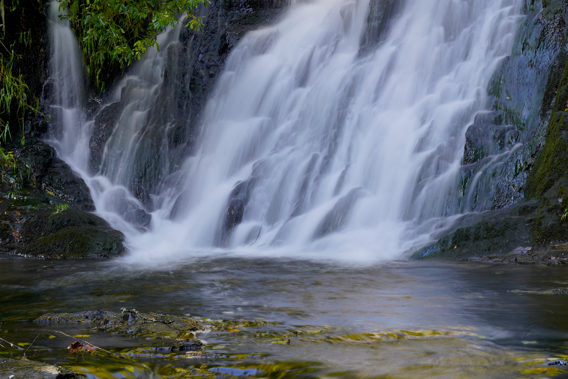 The lacy base of Green Peak Falls lands in a small, calm pool.