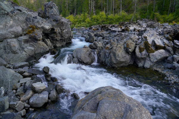 The little Illinois River snakes and cascades through a garden of boulders.