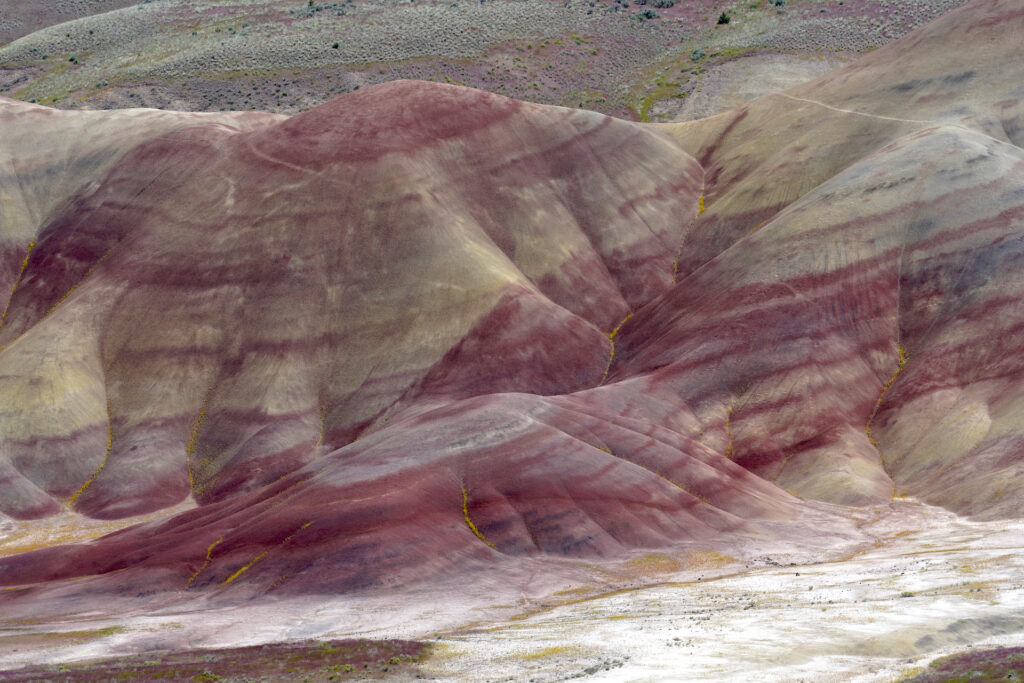 Vivid red stripes run across the folds and rises in Oregon's otherworldly Painted Hills landform.