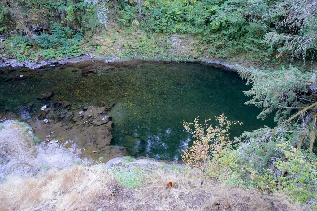 Looking down onto clear teal green water in a swimming hole on the East Fork Lewis River in SW Washington.
