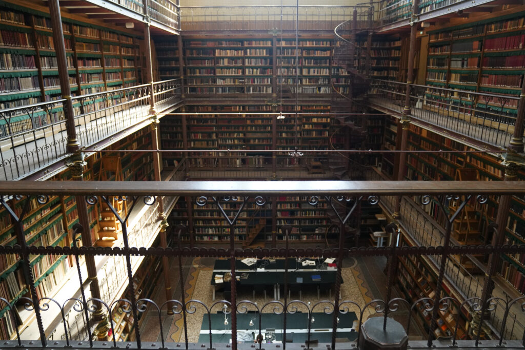 Balconies encircle the three-story tall Cuyper's Library inside Rijksmuseum. The books reach from floor to ceiling.