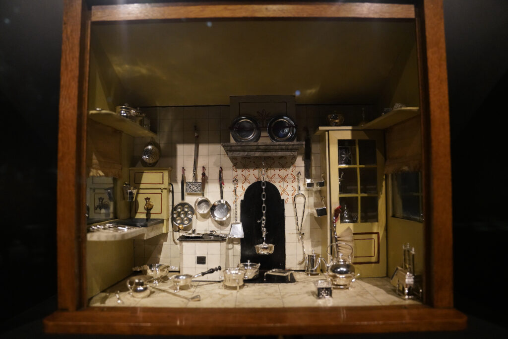 A "miniature museum" of a Victorian-era kitchen, with tiny silver cookware scattered about the floor, is one of many tiny scenes at Rijksmuseum. The entire display fills about one cubic foot.