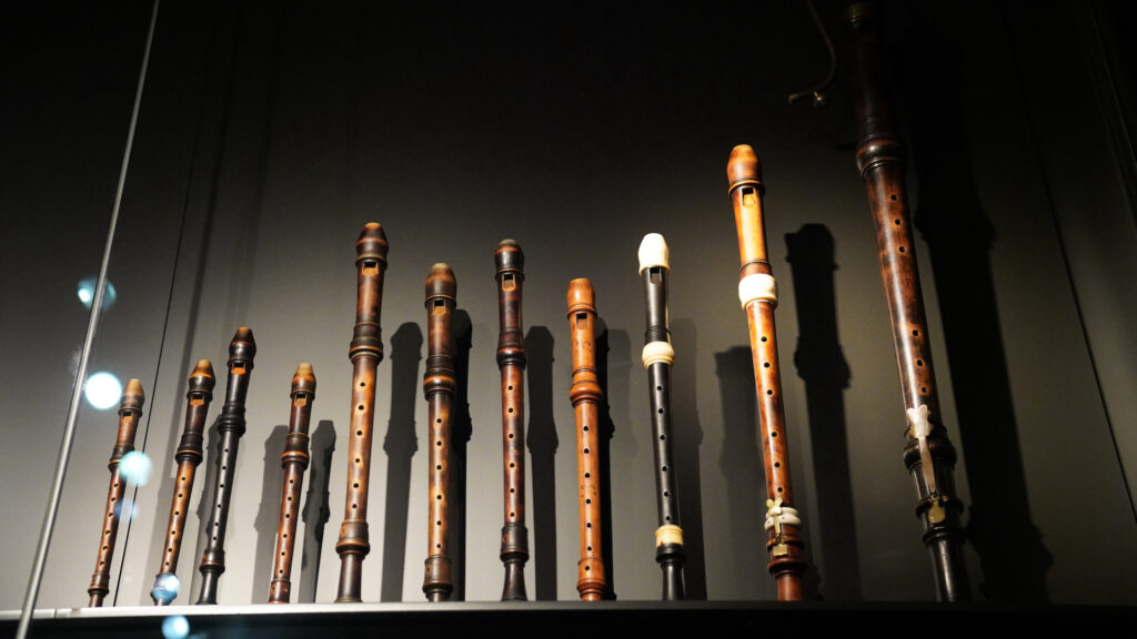 A consort of ancient wooden recorders are displayed standing on end in Rijksmuseum's Special Collection.