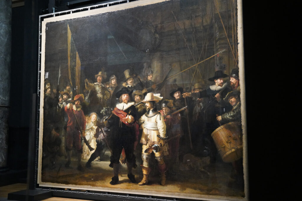 A somewhat side view of "The Night Watch" by Rembrandt is displayed stretched on a modern metal frame as it undergoes restoration at Rijksmuseum in Amsterdam.