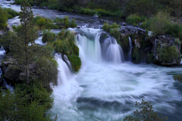 The blue-green waters of Oregon's Deschutes River pour over Steelhead Falls.