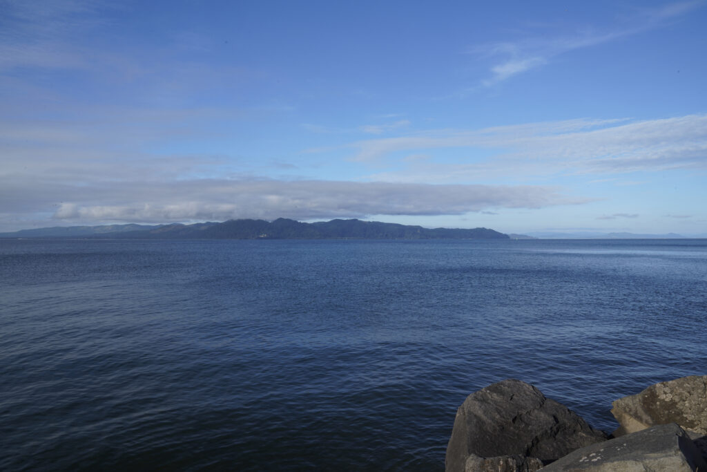 Looking across the Columbia River from Fort Stevens State Park near Astoria, Oregon to distant hills in Washington State.