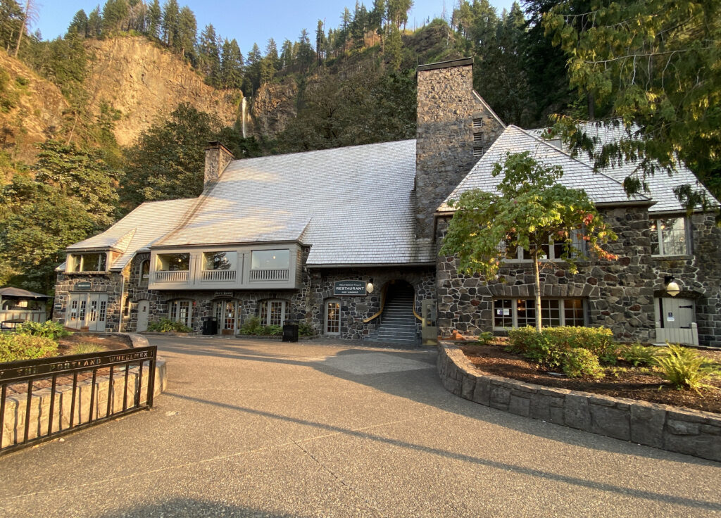 The front of historic Multnomah Falls Lodge in September. Evening approaches and the crowds have all cleared out leaving empty walkways. 