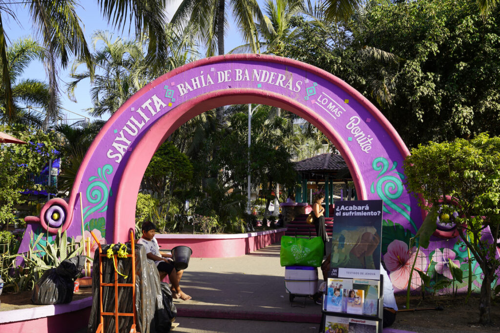 A purple and pink arch at the entrance to main plaza in Salulita Mexico.