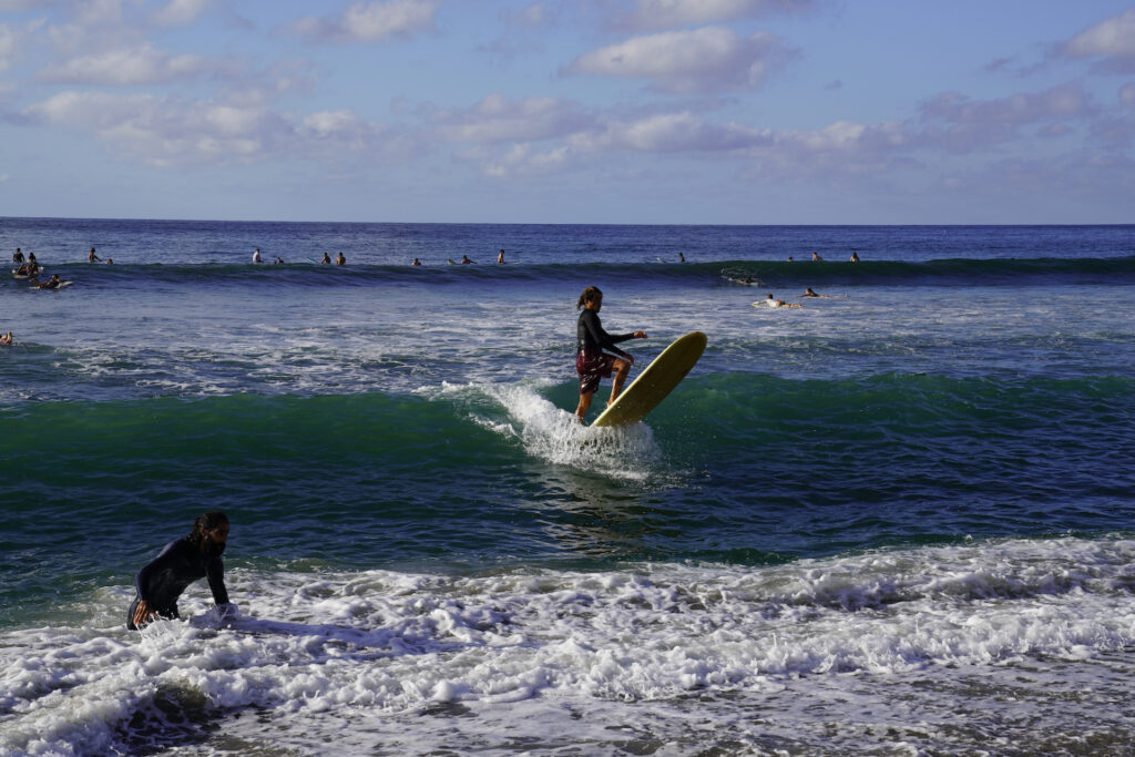 A surfer rides a wave at Sayulita Beach on Mexico's Pacific coast.