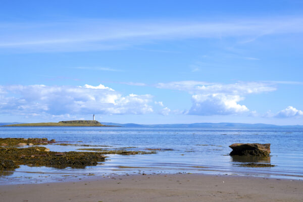 Looking across the placid Firth of Clyde to Plodda Lighthouse on a clear day.