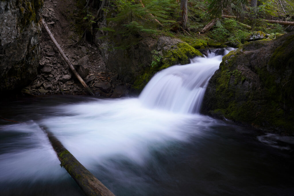 Cold Springs Creek pours over a small ledge into a deep pool deep in the forest below Mt Hood, Oregon.