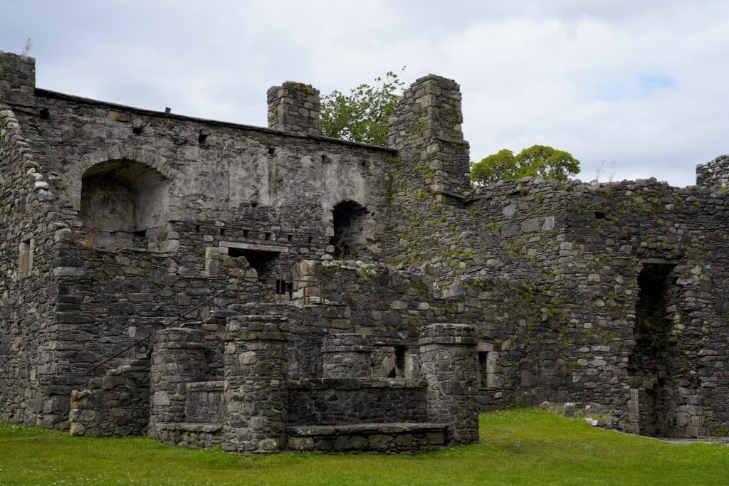 The ruined portion of Dunstaffnage Castle includes the kitchens, a well, barracks, and storage vaults.