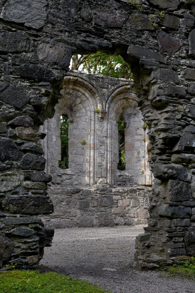 Looking through an arched opening into the ruins of Dunstaffnage Chapel in Scotland.