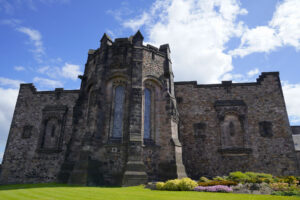 The back side of the Scottish War Memorial building at Edinburgh Castle is flanked by pretty rock garden.