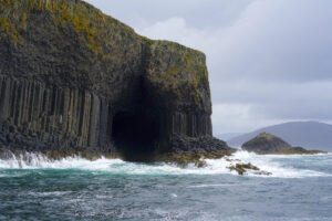 Looking toward Isle of Staffa and Fingal's Cave, a sea cave cut into Staffa's columnar basalt cliffs.