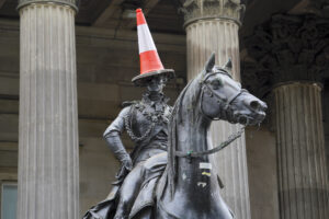 A bright orange traffic cone tops the statue of the Duke of Wellington in downtown Glasgow like a hat.