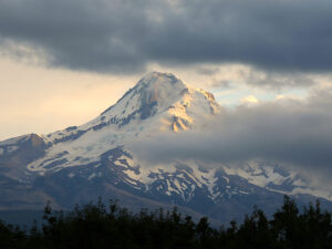 A band of clouds partially covers Mt Hood creating a mysterious scene.