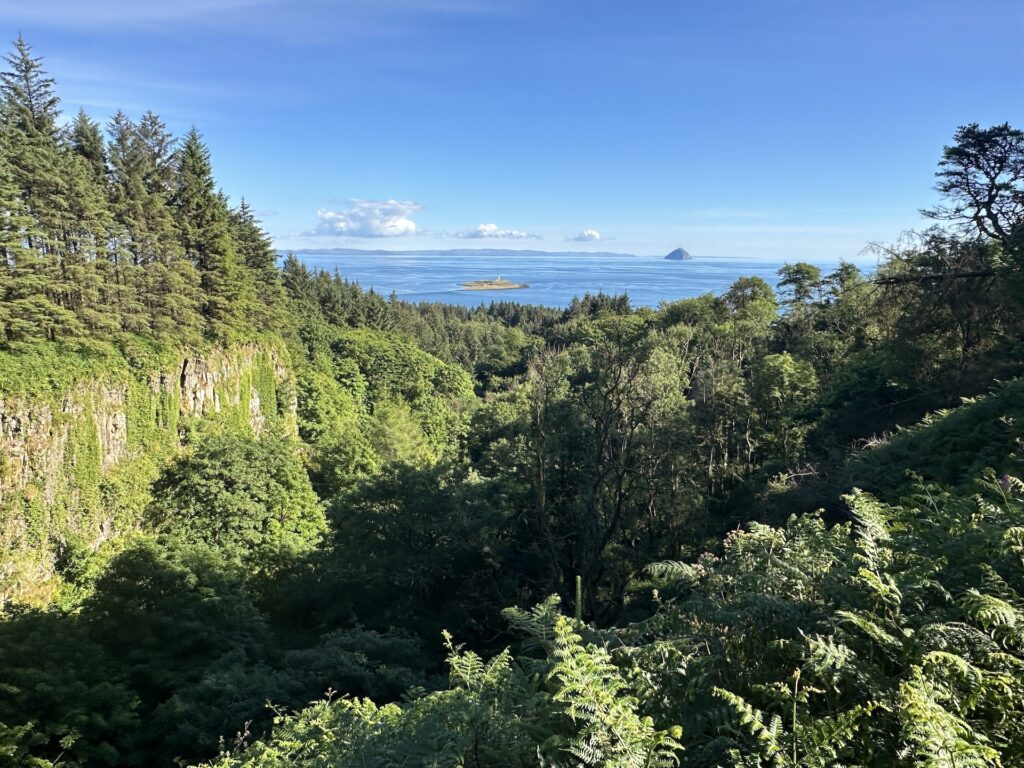 Looking down a wooded canyon on Isle of Arran to the sea.