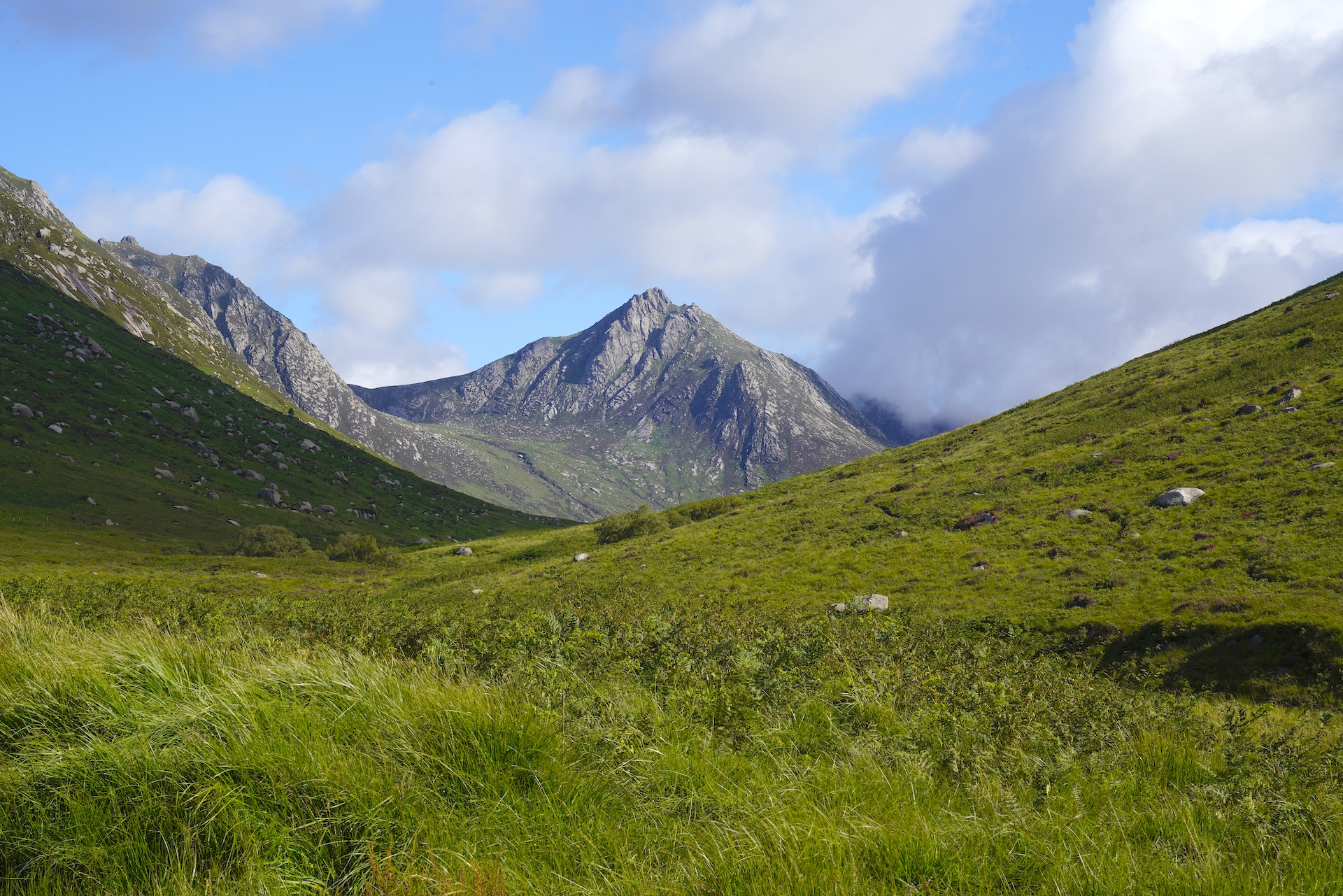 Green meadows sweep up Glen Rosa toward the rocky peak of Goatfell on Scotland's Isle of Arran.