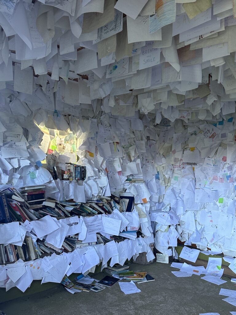 The Interior of the little building known as The Library is covered florr to ceiling in hand-written notes.