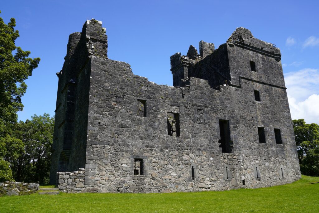 The ruins of Carnasserie Castle in Scotland on a sunny day.