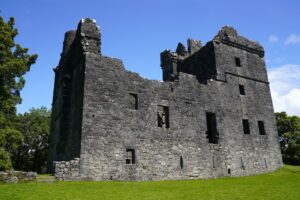 The ruins of Carnasserie Castle in Scotland on a sunny day.