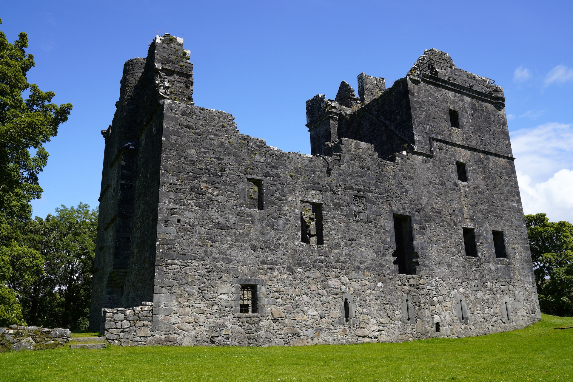 The ruins of Carnasserie Castle in Scotland on a sunny day.