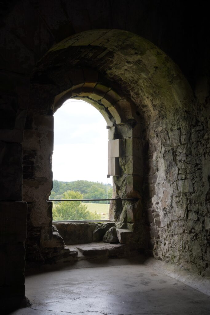 Looking out a large window in Duone Castle, Scotland.