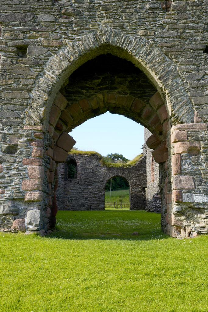 A view looking through the grand arched portal into Skipness Castle in Scotland.