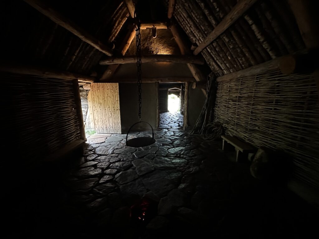 The dark interior of the Turf and Kreel House at Glencoe Scotland, a recreation of a 17th-century farmstead home.