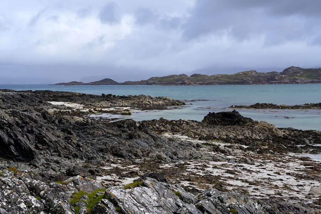 Rocky shores mingle with patches of while sand on Scotland's Isle of Iona.