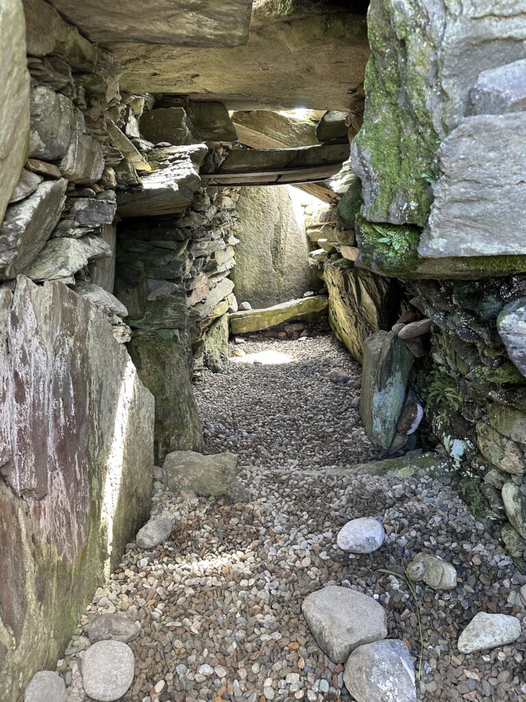 Looking down a tunnel inside Nether Largie South Cairn in Kilmartin Glen, Scotland.