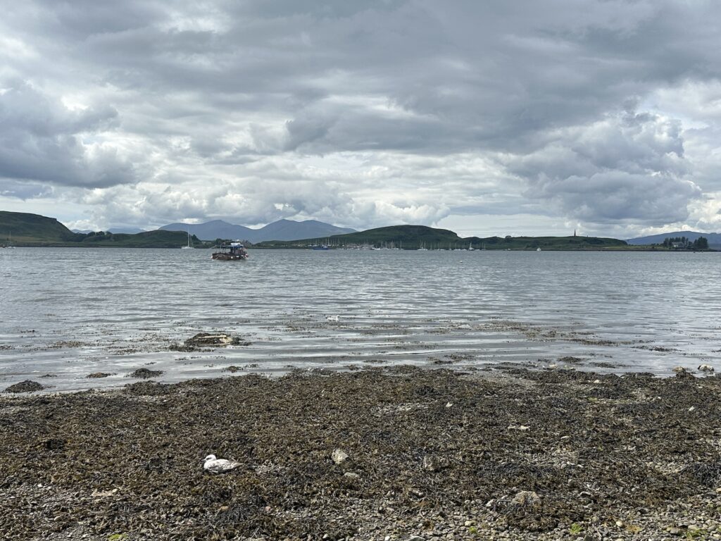 Looking across the water to Isle of Kerrera from Oban, Scotland on a cloudy day.