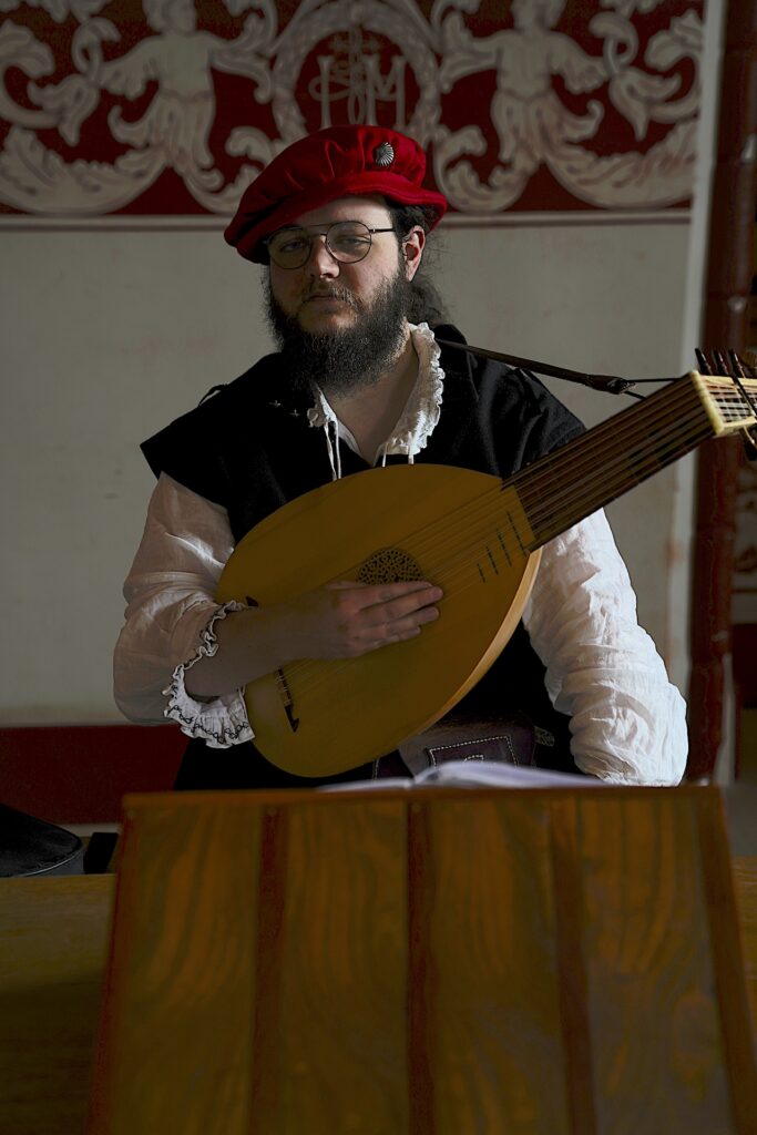 A young man plays the part of the bard in Stirling Castle.