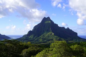 Mt Rotui on Moorea stands proudly next to Opunohu Bay, it's sides shadowed by clouds.